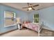 Bright bedroom with a ceiling fan, white trim, and two windows providing natural light at 1225 Madison Green Dr, Fort Mill, SC 29715