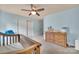 Bedroom featuring blue walls, a ceiling fan, and a wooden crib at 1225 Madison Green Dr, Fort Mill, SC 29715