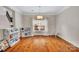 A large bonus room with hardwood floors, light-colored walls, and a large window at 1225 Madison Green Dr, Fort Mill, SC 29715