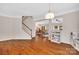 A living room featuring hardwood floors, stairs to the second floor, and a view of the open floor plan at 1225 Madison Green Dr, Fort Mill, SC 29715