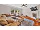 A living room showing hardwood floors, a ceiling fan, a fire place, a couch, and an area rug at 1225 Madison Green Dr, Fort Mill, SC 29715