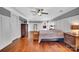Spacious primary bedroom with hardwood floors, paneled walls, and a ceiling fan at 1225 Madison Green Dr, Fort Mill, SC 29715