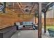 Covered outdoor lounge area with comfortable seating, fan, and privacy screening at 1225 Madison Green Dr, Fort Mill, SC 29715