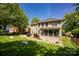 Large backyard showcases ample green space, a deck, screened-in porch, and privacy fencing at 12416 Kane Alexander Dr, Huntersville, NC 28078