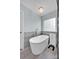 Bathroom featuring a freestanding tub, stylish tiling, and a glass-enclosed shower at 12416 Kane Alexander Dr, Huntersville, NC 28078