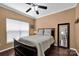 Cozy bedroom with neutral walls, ceiling fan, and a comfortable bed with dark wood frame at 12416 Kane Alexander Dr, Huntersville, NC 28078