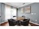 Inviting dining area featuring modern decor, a round wooden table, and comfortable seating for four at 12416 Kane Alexander Dr, Huntersville, NC 28078