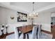 Elegant dining room featuring a wooden table, upholstered chairs, and a decorative chandelier at 12416 Kane Alexander Dr, Huntersville, NC 28078