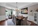 Bright dining room with a wooden table, upholstered chairs, and natural light from large windows at 12416 Kane Alexander Dr, Huntersville, NC 28078