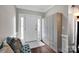 Bright entryway with hardwood floors, a storage bench, and a white front door with sidelights at 12416 Kane Alexander Dr, Huntersville, NC 28078