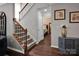 Hallway featuring staircase, wood floors, and decor at 12416 Kane Alexander Dr, Huntersville, NC 28078