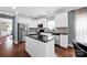 Well-lit kitchen featuring white cabinets, stainless steel appliances, and an island with black countertops at 12416 Kane Alexander Dr, Huntersville, NC 28078