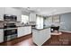 Modern kitchen with white cabinets, stainless steel appliances, and a black countertop island at 12416 Kane Alexander Dr, Huntersville, NC 28078