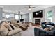 Bright, open-concept living area with a fireplace, kitchen view, and comfortable seating at 12416 Kane Alexander Dr, Huntersville, NC 28078