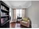 Cozy room with a comfortable chair, bookshelf, and large window at 12416 Kane Alexander Dr, Huntersville, NC 28078