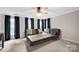 Spacious living room features plush seating, neutral decor, and a ceiling fan for comfort at 12416 Kane Alexander Dr, Huntersville, NC 28078