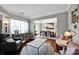 Inviting living room with hardwood floors, large windows, and an open view of the adjacent dining area at 12416 Kane Alexander Dr, Huntersville, NC 28078
