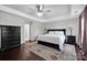 Spacious bedroom showcasing dark wood floors and stylish furnishings at 12416 Kane Alexander Dr, Huntersville, NC 28078