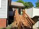 View of wooden stairs leading to the home's rear screened porch with lift at 125 Hunter St, Salisbury, NC 28144