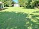 Wide shot of the green backyard with mature trees and a shed at 125 Hunter St, Salisbury, NC 28144