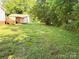 View of expansive backyard with lush green grass and mature trees at 125 Hunter St, Salisbury, NC 28144