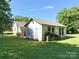 The home's backyard features an additional building with a pile of cinder blocks and clear skies at 125 Hunter St, Salisbury, NC 28144