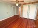 Bedroom featuring wood floors, a closet, ceiling fan, and natural light at 125 Hunter St, Salisbury, NC 28144