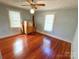 Bedroom featuring two windows, hardwood floors, ceiling fan, and natural light at 125 Hunter St, Salisbury, NC 28144