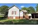 Side exterior view of home with red shutters and lush green lawn at 125 Hunter St, Salisbury, NC 28144