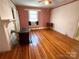 Cozy living room featuring hardwood floors, fireplace, natural light, and vintage decor at 125 Hunter St, Salisbury, NC 28144