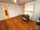 View of living room showcasing hardwood floors, vintage heater, and vintage mantle at 125 Hunter St, Salisbury, NC 28144