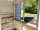 Enclosed porch with flaking paint offers a peek at the backyard at 125 Hunter St, Salisbury, NC 28144