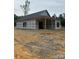 An unfinished home shows exterior with covered porch and newly installed roof at 128 Loblolly Dr, Mount Gilead, NC 27306