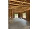Unfinished home interior shows framing, creating spacious open floor plan, ready for customization at 128 Loblolly Dr, Mount Gilead, NC 27306