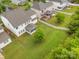 Expansive backyard featuring a lush lawn, white picket fence, mature trees and screened in porch at 12832 Heath Grove Dr, Huntersville, NC 28078