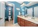 Stylish bathroom with dual vanities, tile flooring, updated fixtures, and blue accent wall at 12832 Heath Grove Dr, Huntersville, NC 28078
