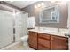 Bathroom featuring a glass shower, vanity with double sinks, and a framed mirror at 12832 Heath Grove Dr, Huntersville, NC 28078