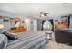 Relaxing bedroom with ceiling fan, leather recliner, and neutral gray wall paint at 12832 Heath Grove Dr, Huntersville, NC 28078