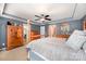 Serene bedroom boasts tray ceilings, neutral carpet, wooden furniture, and calming blue-gray wall paint at 12832 Heath Grove Dr, Huntersville, NC 28078