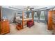 Spacious bedroom featuring a four-poster bed, neutral carpet, tray ceiling, and soft natural light at 12832 Heath Grove Dr, Huntersville, NC 28078