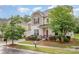 Charming two-story home featuring well-maintained landscaping, a cozy front porch, and a welcoming red door at 12832 Heath Grove Dr, Huntersville, NC 28078