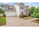 Beautiful two-story home boasts a wide driveway, attached garage, and professionally landscaped front yard at 12832 Heath Grove Dr, Huntersville, NC 28078