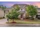 Two-story home with craftsman details, a red front door, beautiful landscaping, and curb appeal at sunset at 12832 Heath Grove Dr, Huntersville, NC 28078