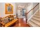 Inviting foyer with hardwood floors, staircase, and stylish bench at 12832 Heath Grove Dr, Huntersville, NC 28078