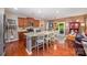 Open kitchen with a granite island, modern appliances, and hardwood floors at 12832 Heath Grove Dr, Huntersville, NC 28078