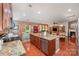 Open kitchen with granite countertops, a center island, and views into the living area at 12832 Heath Grove Dr, Huntersville, NC 28078
