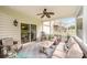 Inviting screened porch with cozy seating, ceiling fan, and pleasant outdoor views at 12832 Heath Grove Dr, Huntersville, NC 28078