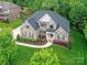 Stunning aerial view of the brick home with lush greenery surrounding the property at 129 Overlook Ridge Ln, Davidson, NC 28036