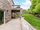 Brick home with a patio and stairs leading to a deck and beautifully landscaped backyard at 129 Overlook Ridge Ln, Davidson, NC 28036