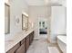 Elegant bathroom with double vanity, stone countertops, and access to the main bedroom at 129 Overlook Ridge Ln, Davidson, NC 28036